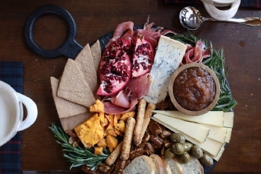 Board of aged cheeses with cured meats